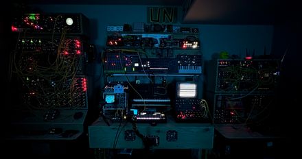 a wall of synthesizers housed in splintered plywood - oscilloscope dancing - CRT scan-lining